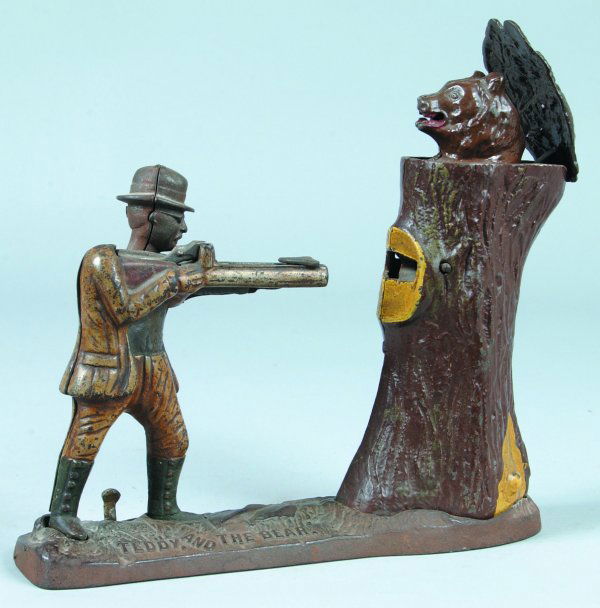 Cast Iron Teddy and the Bear Mechanical Bank manuf: Cast Iron Teddy and the Bear Mechanical Bank manufactured by J. E. Stevens and Co., bank has good operation, Teddy Roosevelt has replaced head, bank is missing trap, overall good condition with paint