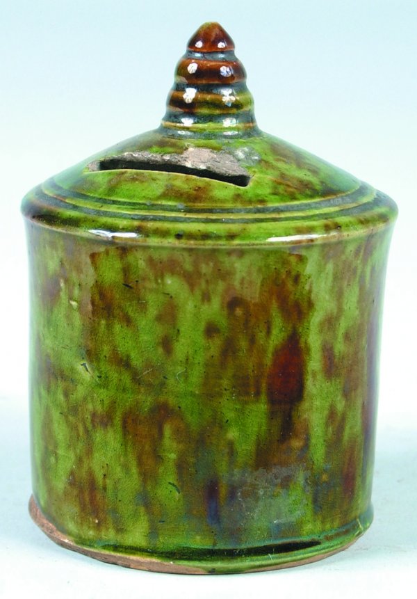 Earthenware Canister Form Bank, bank stands 4-1/4": Earthenware Canister Form Bank, bank stands 4-1/4" tall, spinach and brown color having wear and a chip in coin slot, overall good condition.
