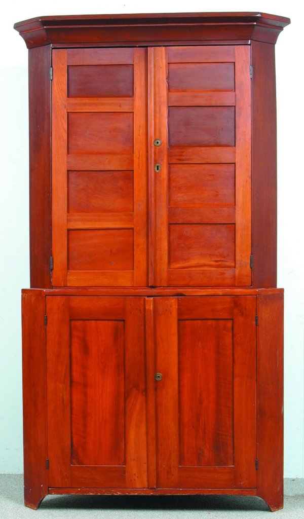 Country Federal Cherry Two Part Step-Back Blind Do: Country Federal Cherry Two Part Step-Back Blind Door Corner Cupboard. Molded cornice, two upper doors with 4 graduated panels, above two lower paneled doors and cut-out feet. Condition: Refinished and