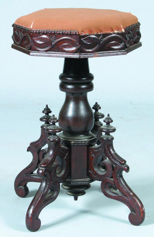 Victorian Walnut Carved and Molded Adjustable Orga: Victorian Walnut Carved and Molded Adjustable Organ Stool. Octagonal top with trailing vine skirt, vasiform pedestal supported by four scrolled legs with turned finials. Condition: Tears to the uphols