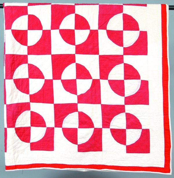 Geometric Patchwork Quilt with red and white circl