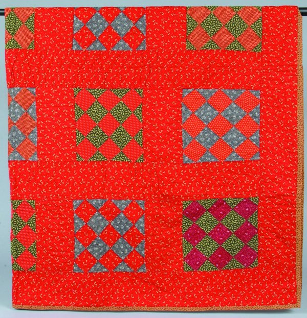 Geometric Patchwork Quilt having muti-colored diam