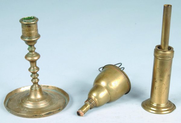 Three Brass Lighting Devices; first is European Can: Three Brass Lighting Devices; first is European Candlestick with saucer base, 6"h. Good with denting on saucer base; second is a Music Stand Lamp marked J.W. Pepper, Phila. 5 ¾"h. Good; and third is 