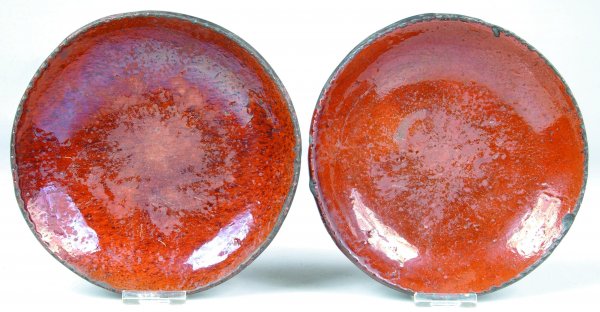 Two Redware Plates with orange and manganese glaze: Two Redware Plates with orange and manganese glaze, 7-1/4"dia., (edge chips and glaze loss).