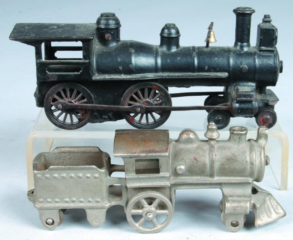 Two Cast Iron Steam Locomotives; first is painted : Two Cast Iron Steam Locomotives; first is painted black with patented date June 88, 3-1/2"h.x7-3/4"l., (good condition). Second is a one piece steam engine with tender and nickel plated finish, 2-3/4"