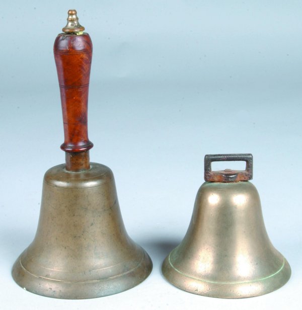 Two Brass Bells; first is a school bell with turne: Two Brass Bells; first is a school bell with turned burl wood handle with finial top, 10-1/2"h., (good condition); second bell has cast iron buckle form hanger, 4-3/4"h., (good condition).