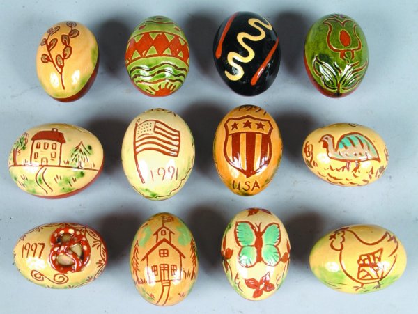 Twelve Breininger Redware Sgraffitto Decorated Eggs: Twelve Breininger Redware Sgraffitto Decorated Eggs including American Flag, school house, animals and floral, various years average size is 2 ½"h. (very good condition).