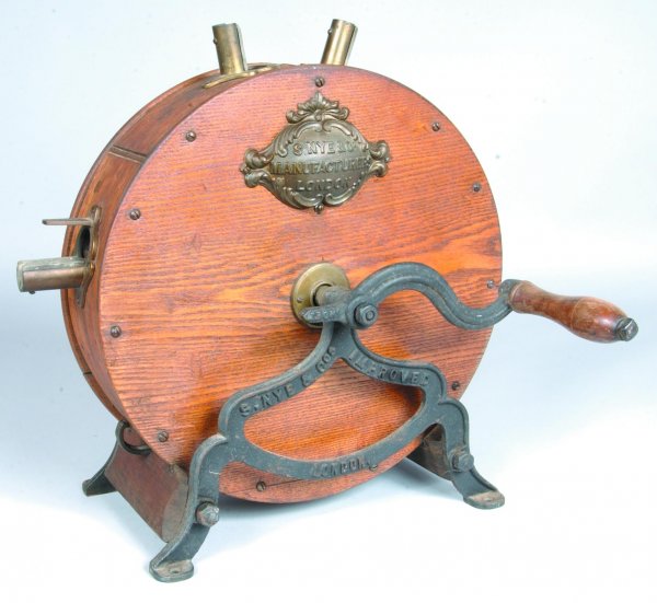 S. Nye & Co. London Counter Top Knife Sharpener, r: S. Nye & Co. London Counter Top Knife Sharpener, round oak case with cast iron frame, signed brass plaque, 18 ¼"h.18"l.( good condition).
