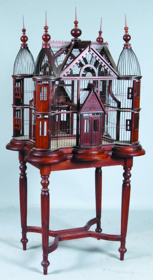 Victorian Style Wood and Wire Bird Cage with Stan: Victorian Style Wood and Wire Bird Cage with Stand, 20th century, mixed woods, having dome top corners, turned finials, pull out lower tray, cut work, stand with turned legs and hour glass form suppor