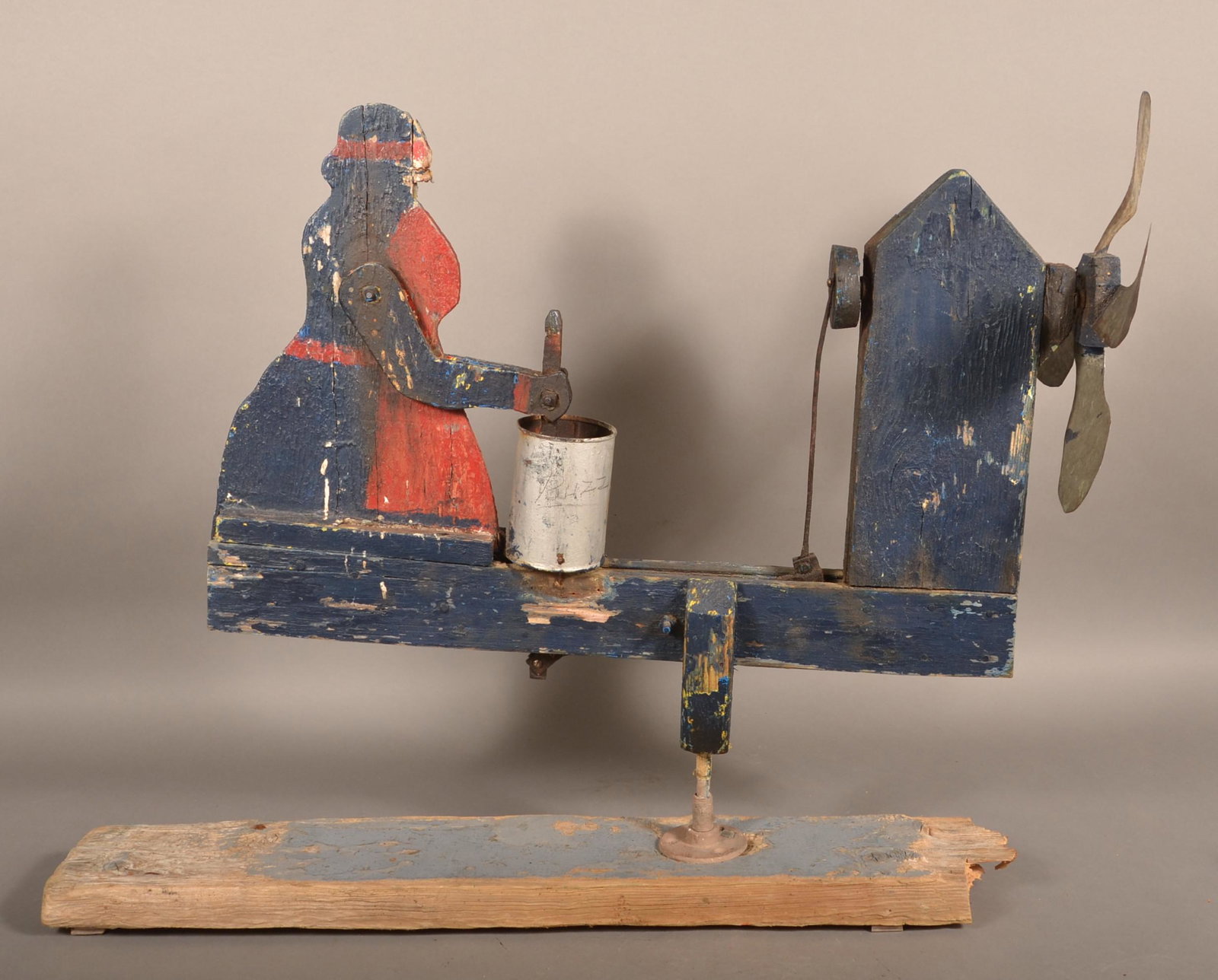 Antique/Vintage Folk Art Painted Wood Whirligig.: Antique/Vintage Folk Art Painted Wood Whirligig. Woman churning butter. 26"h. x 26"l. x 14"w. Condition: Fair with weathering and losses.