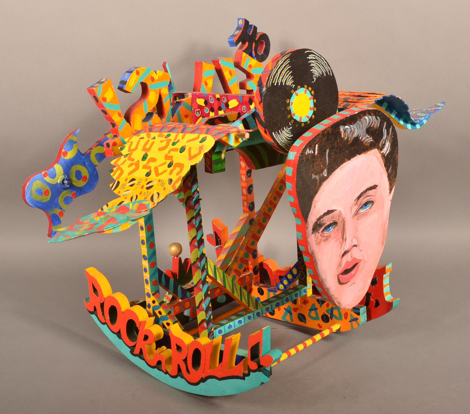 Vintage Folk Art Painted Wood Whirligig.: Vintage Folk Art Painted Wood Whirligig. Outsider "Rock & Roll Elvis". 21"h. x 18"l. x 34"w. Condition: Good with wear.
