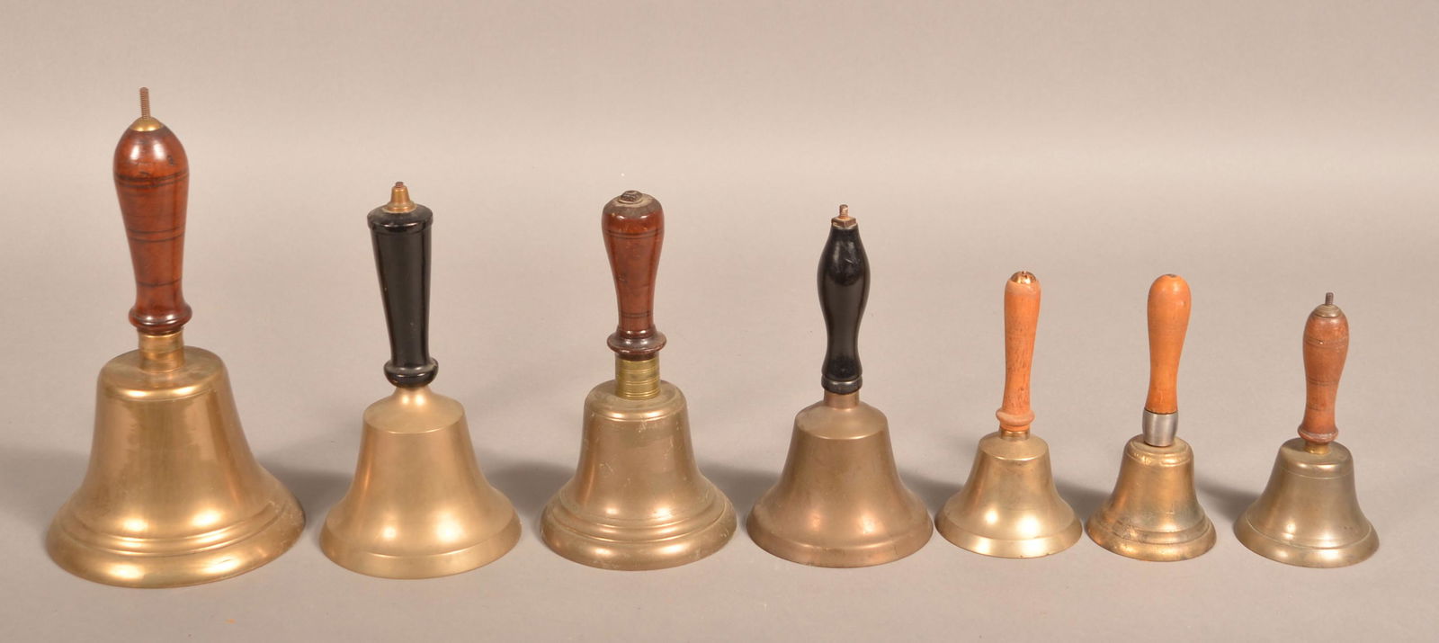 7 Antique Brass Hand bells with Turned Wood Handles. (1 of 3)