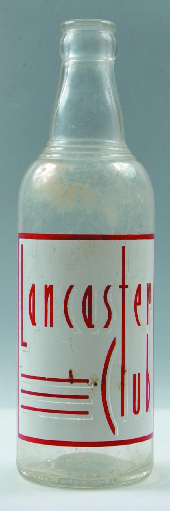 Dr. Pepper Bottling Co. Inc. (Lancaster Club)clear: Dr. Pepper Bottling Co. Inc. (Lancaster Club)clear crown top soda bottle, red and white,8.50", Condition: Good.