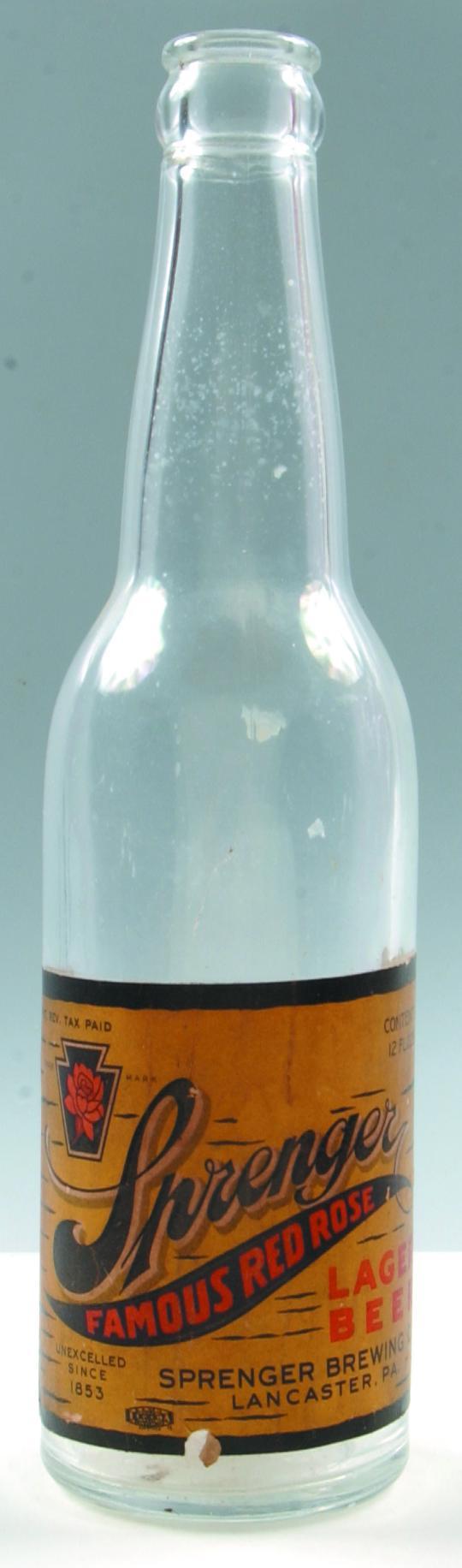 Sprenger Brewing Co. Lancaster, Pa. clear crown to: Sprenger Brewing Co. Lancaster, Pa. clear crown top bottle with ( Sprenger Famous Red Rose Lager Beer) paper label, smooth bottom, 9.50", Condition: Good with minor loss on label.
