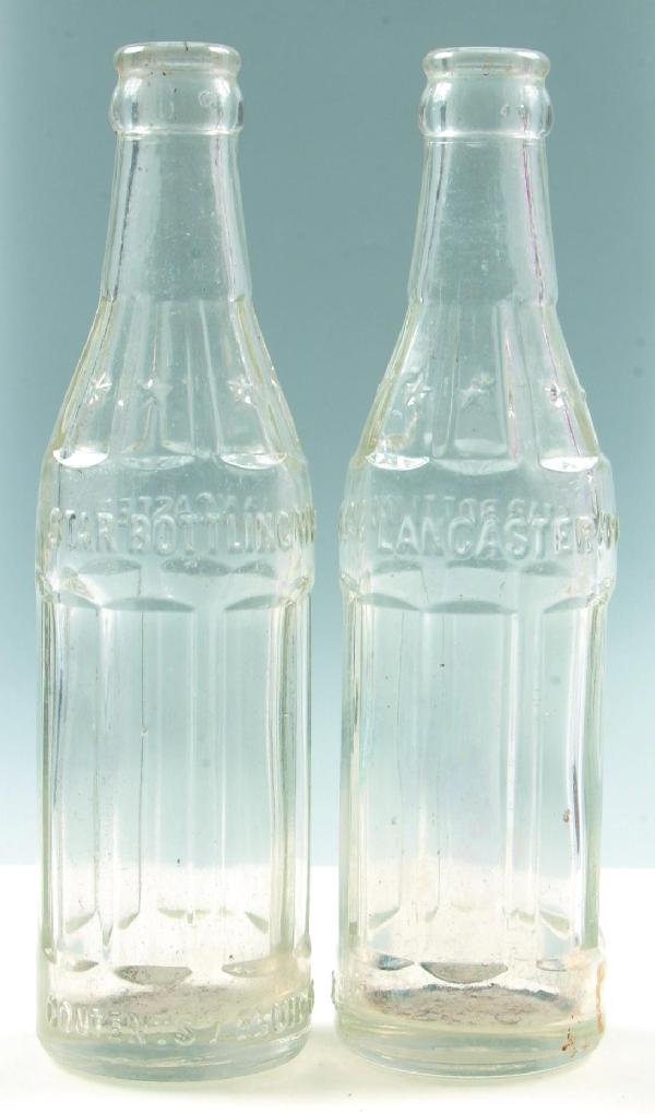 Star Bottling wks. Lancaster, Pa. Two clear crown: Star Bottling wks. Lancaster, Pa. Two clear crown top soda bottles, 8.25", Condition: Good.