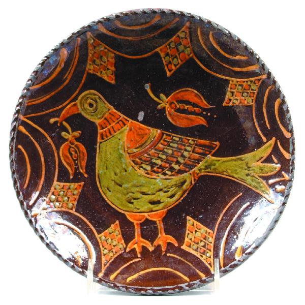 Greg Shooner 2005 Redware Slip Decorated 8 ½" Plate: Greg Shooner 2005 Redware Slip Decorated 8 ½" Plate with central bird having flower in beak, border with swags, Condition: Good with spot with glaze loss.