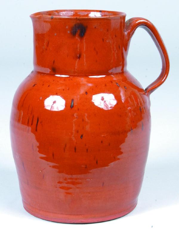 Redware Pitcher decorated with manganese speckles,: Redware Pitcher decorated with manganese speckles, illegible makers mark, applied handle, 8 ½"h. Condition: Good.