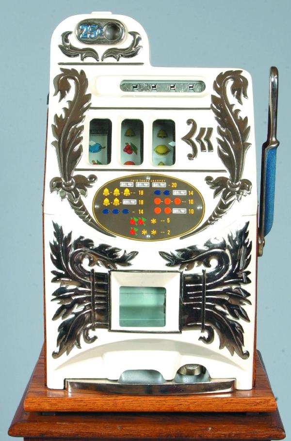 Twenty-Five Cent "Extra Bell" Model Slot Machine,: Twenty-Five Cent "Extra Bell" Model Slot Machine, factory restored and refurbished, having modern oak cabinet with brass paw feet, 60"overall all, Condition: Slot machine very good.