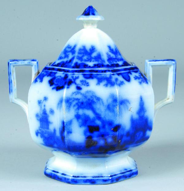 Flow Blue Ironstone China "Scinde" Covered Sugar B: Flow Blue Ironstone China "Scinde" Covered Sugar Bowl marked Alcock. 7" high. Condition: Minor rim chips.