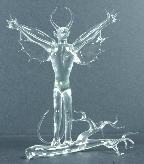 Michael Dorofee Blown Glass Jersey Devil Sculpture: Michael Dorofee Blown Glass Jersey Devil Sculpture standing on branch, cow head, human body wings and hoof feet, signed, 9 ¼"h. x 7 ¾"w. Condition: Points off wing and tail.