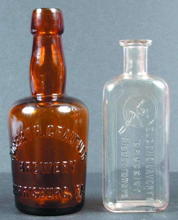 Brewery and Medicine Glass Bottle, 1st is a Robert: Brewery and Medicine Glass Bottle, 1st is a Robert H. Graupner Brewery Harrisburg, Pa. Amber pony size bottle with embossed lettering, 2nd is a Eugene Laverty Druggist Middletown, Pa. Clear medicine b