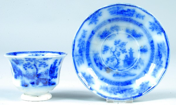 Flow Blue Ironstone China "Chapoo" Handleless Cup: Flow Blue Ironstone China "Chapoo" Handleless Cup and Saucer marked Wedgwood. Condition: Good.