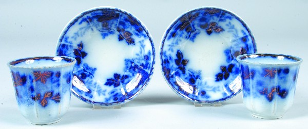 Two Flow Blue Ironstone China Strawberry Pattern H: Two Flow Blue Ironstone China Strawberry Pattern Handleless Cups and Saucers, unmarked. Condition: Good.