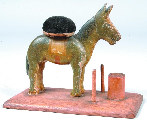 Horse form Sewing Stand, full body of horse with c: Horse form Sewing Stand, full body of horse with circular pin cushion on back, two spool holders and cylinder form holder on rectangle base, polychrome painted, 5 ¾"h. x7 ½"l. 4"w. Condition: Good.