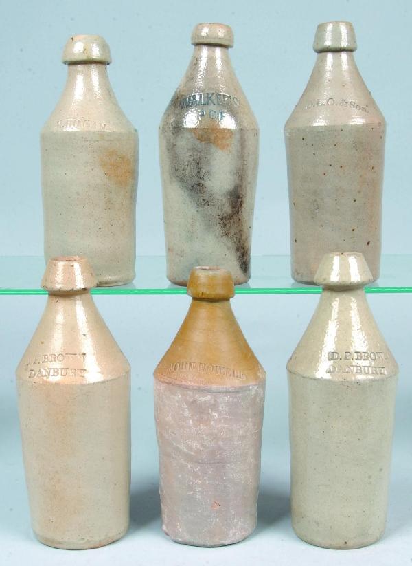 Six Stoneware Pottery Salt Glazed Beer Bottles wit: Six Stoneware Pottery Salt Glazed Beer Bottles with impressed names; M. HOGAN, D.L.O. & Son, WALKER'S, JOHN HOWELL and two D.P. BROWN. 9-3/4" to 11" high. Condition: Minor chips.