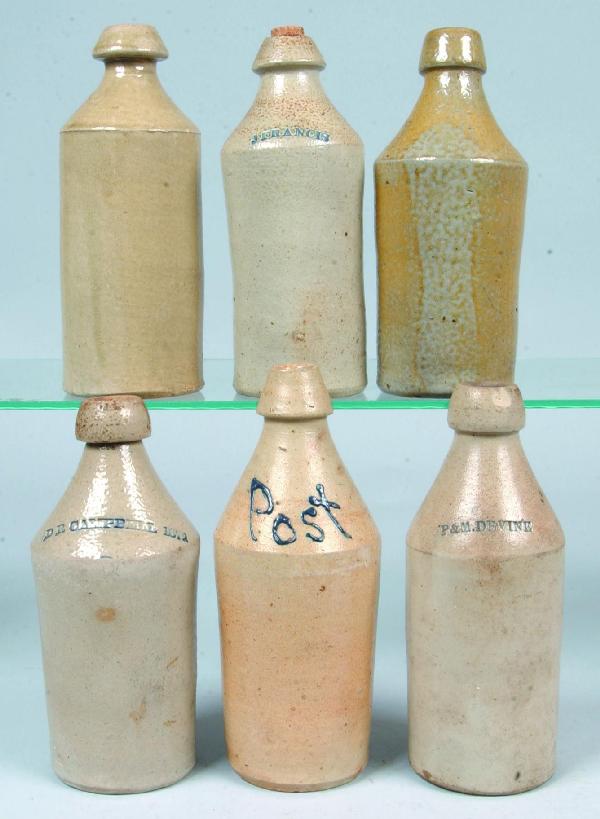 Six Stoneware Pottery Salt Glazed Beer Bottles, so: Six Stoneware Pottery Salt Glazed Beer Bottles, some with impressed names; Post (in blue slip), P & M. DEVINE, D.R. CAMPBELL 1872, J. FRANCIS. 9-1/4" to 10-1/2" high. Condition: Some chips.