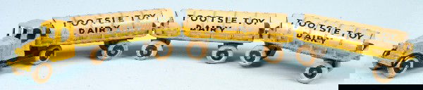 Tootsie Toy Milk Truck and Three Tank Trailers mar: Tootsie Toy Milk Truck and Three Tank Trailers marked "Tootsie Toy Dairy". 1-5/8"h x 13-1/4"l. Condition: Good with light wear, wheels intact but show signs of dry rot.