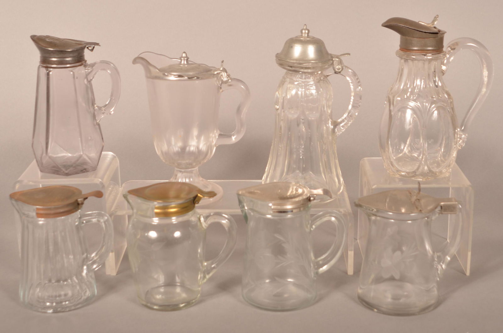 Eight Various Antique Colorless Glass Syrup Jugs. (1 of 4)