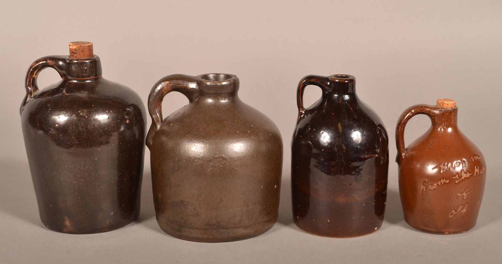 Four Antique Brown Glazed Stoneware Jugs. (1 of 3)