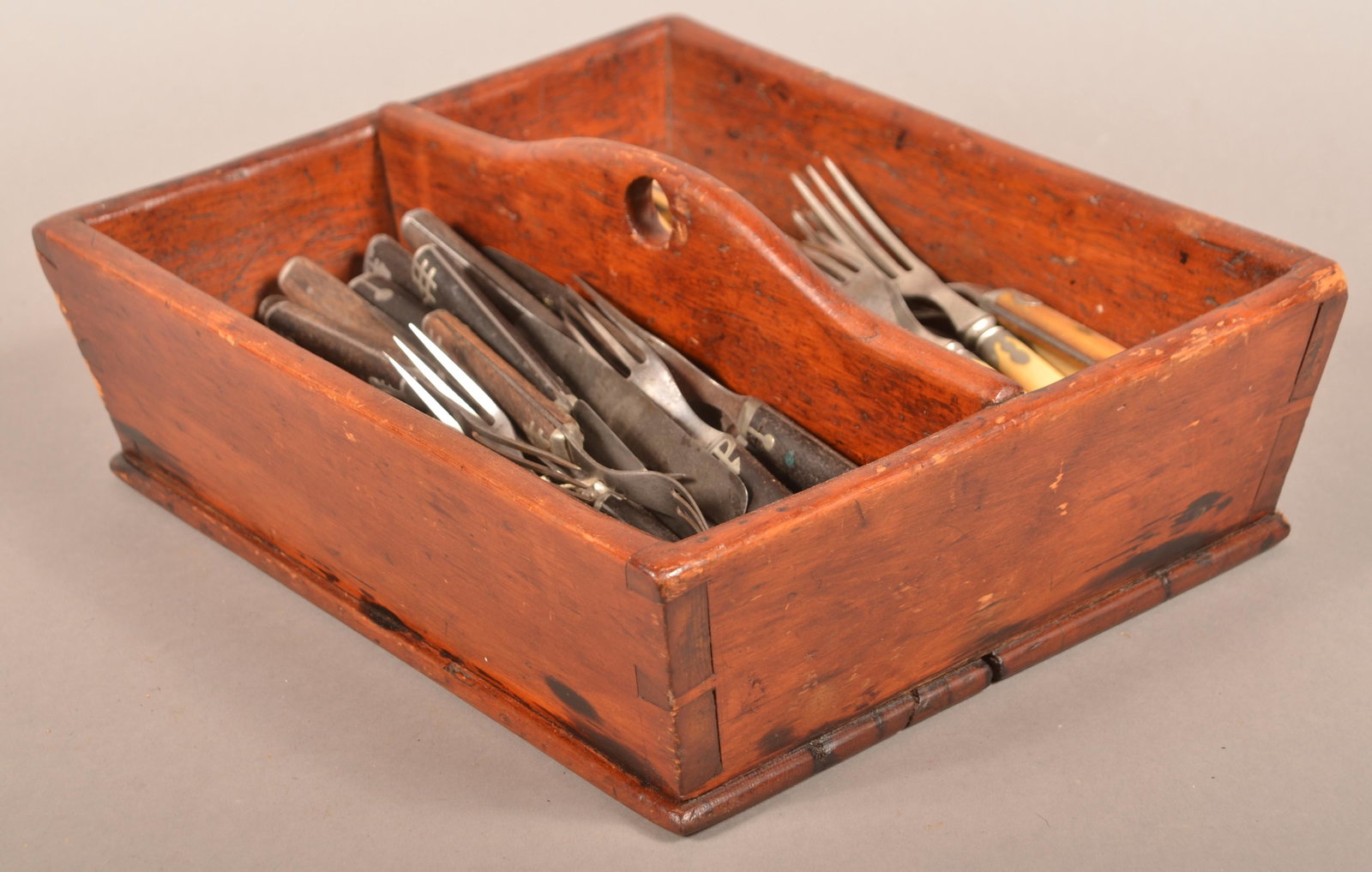 Antique Softwood Utensil Box.: Antique Softwood Utensil Box. With period knives and forks. One set with pewter inlaid bone handles and one set with pewter inlaid wood handles. Tray measures 13-1/4" wide. Conditon: Good with wear.