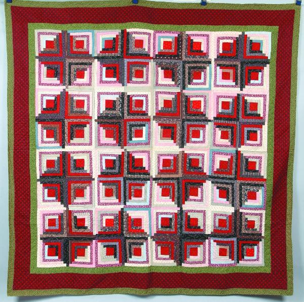 Log Cabin Sunshine and Shadow Patchwork Quilt, mul: Log Cabin Sunshine and Shadow Patchwork Quilt, multi-colored fabric with red and green border, printed paisley backing, 77" x 77", from the ex. George Heigis Estate, Condition: Very good.