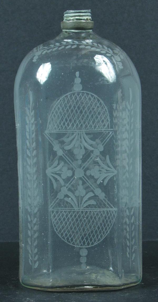 Stiegel-type Blown Colorless Glass Cologne Bottle : Stiegel-type Blown Colorless Glass Cologne Bottle having lattice, floral and foliate copper wheel engraved decorations and pewter collar, missing cap. 7-1/4" high. Condition: Good.