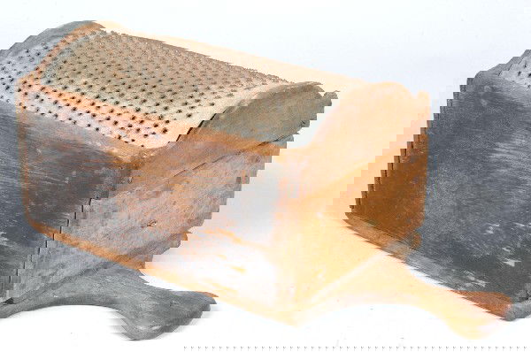 Primitive 19th Century Pennsylvania Softwood Grate: Primitive 19th Century Pennsylvania Softwood Grater with punched-tin arched panel, encased drawer and flared hanging arm. 16" long overall. Condition: Good with expected wear.