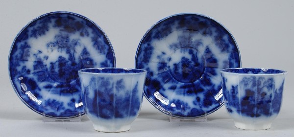 Two Flow Blue Scinde Pattern Ironstone China Pane: Two Flow Blue Scinde Pattern Ironstone China Paneled Handleless Cups and Saucers by J. & G. Alcock. Condition: Good.