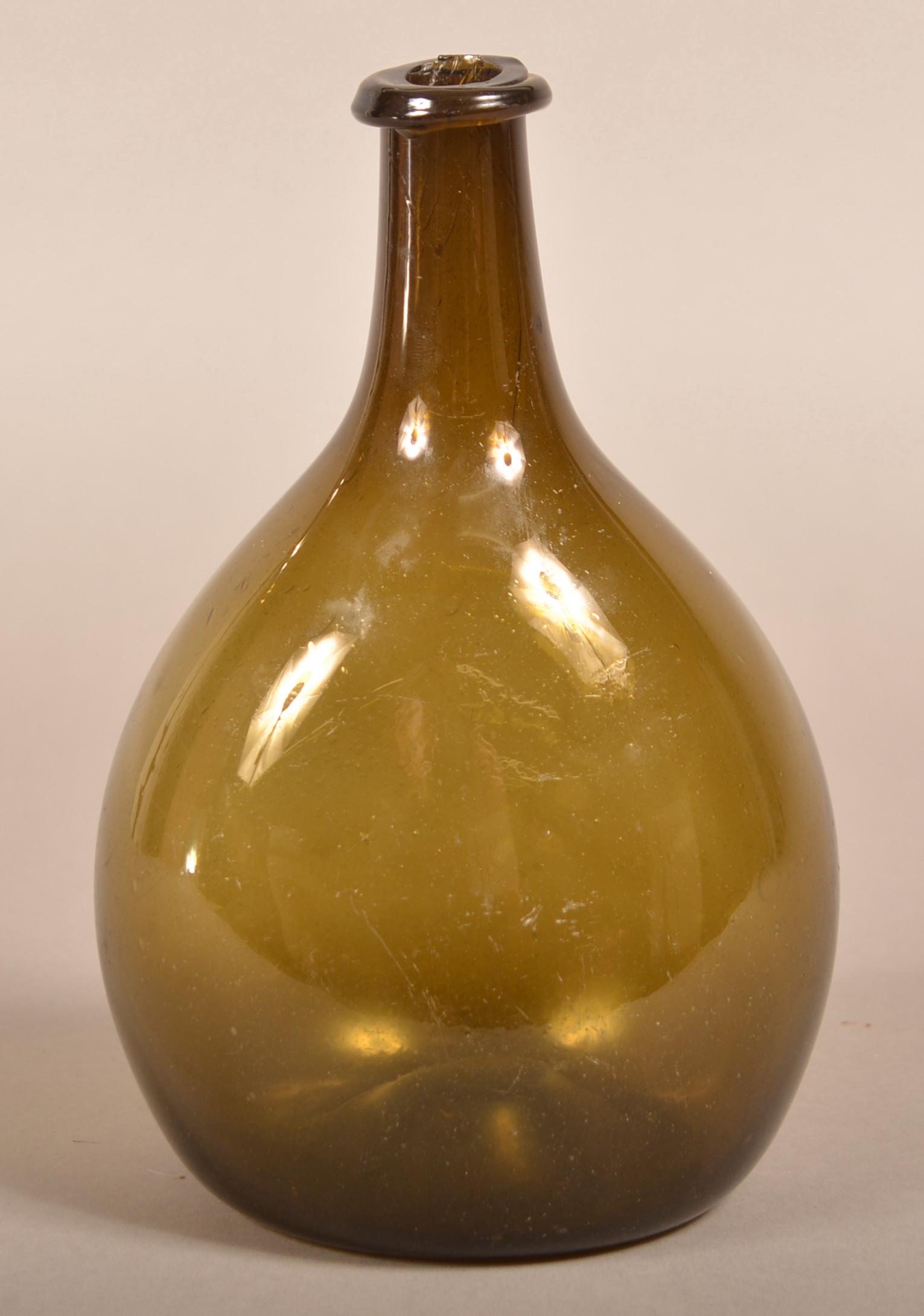 Free-Blown Medium Olive Green Chestnut Flask.: Free-Blown Medium Olive Green Chestnut Flask. Ovoid body with medium neck and crude-applied rounded mouth and concave base with pontil mark. Probably New England. Circa 1780-1830. 8-1/4"h. Condition:
