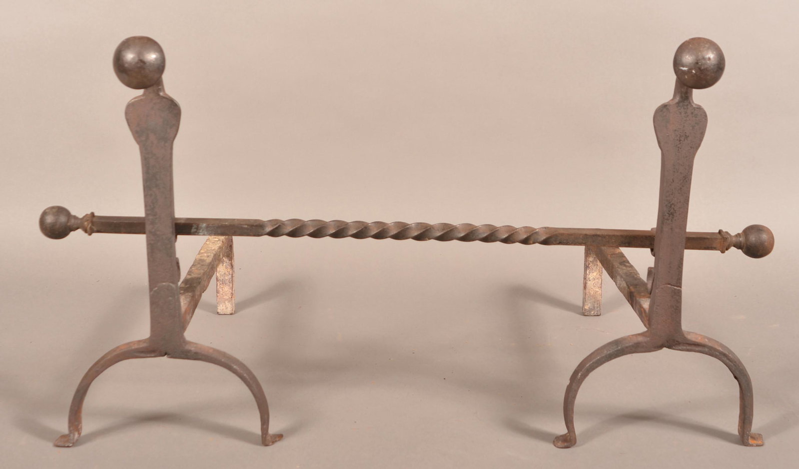 Pair of Antique Iron Andirons with Crossbar.: Pair of Antique Iron Andirons with Crossbar. 19"h. Condition: Good with wear and loss.