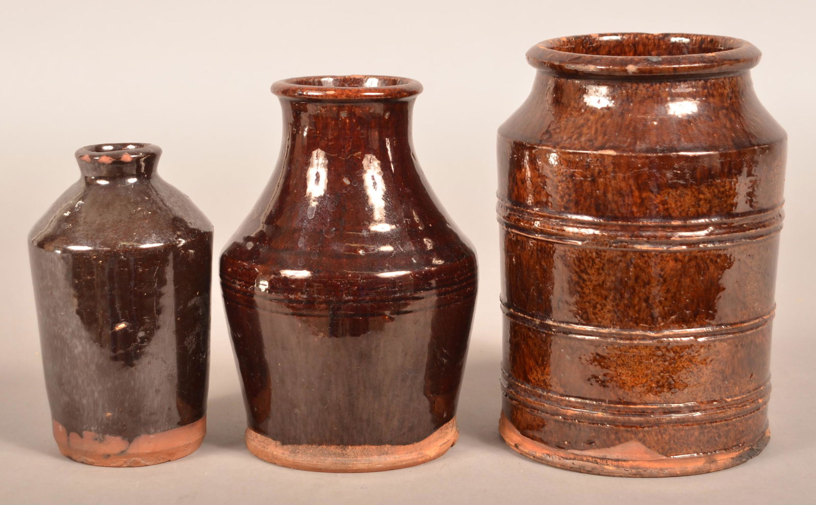Three Various Glazed Redware Storage Jars.: Three Various Glazed Redware Storage Jars. 6" to 7-3/4"h. Condition: Good with chips.