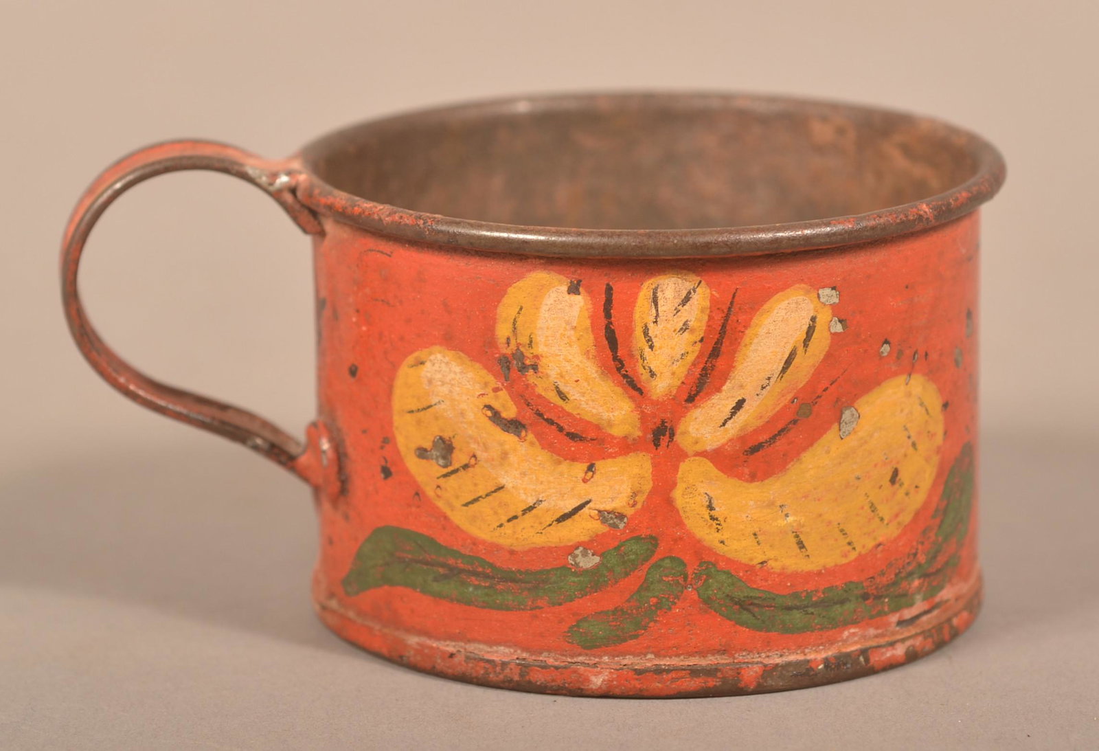 Pennsylvania 19th Century Red Toleware Child's Mug.: Pennsylvania 19th Century Red Toleware Child's Mug. Having yellow, white and green floral and foliate decoration on red ground. 1-3/4"h. Condition: Good with wear and paint chips.