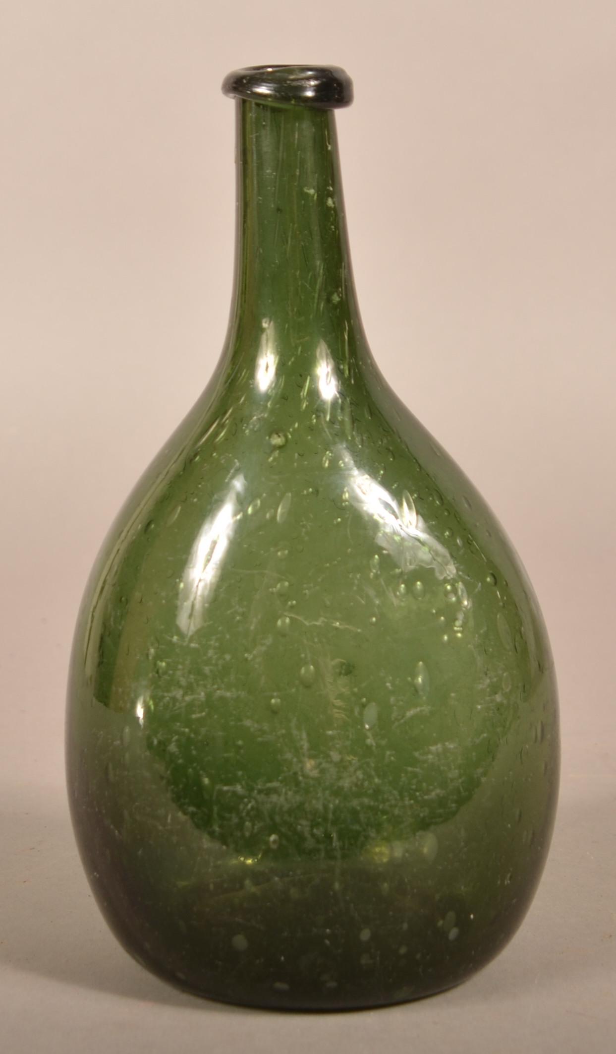 Blown Dark Olive Green Chestnut Flask.: Blown Dark Olive Green Chestnut Flask. Ovoid body with medium neck and crude applied rounded mouth, concave base with pontil mark. Probably New England. Circa 1780-1830. 6-1/4" h. Condition: Very good