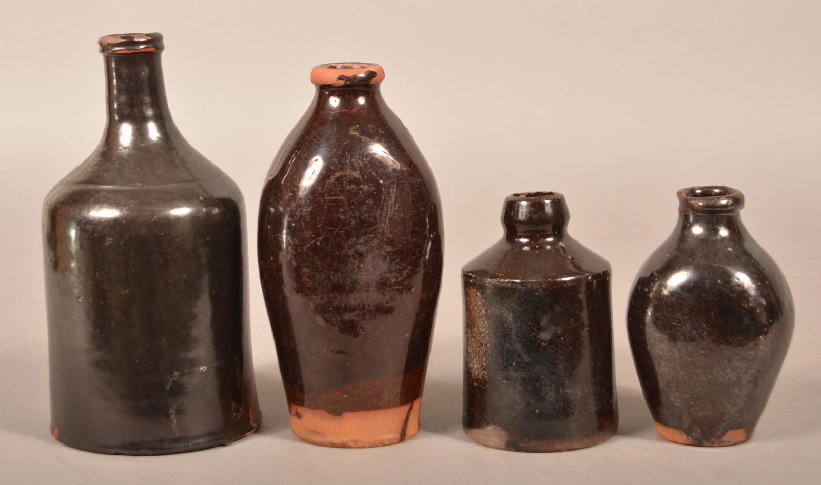 Four Various 19th Century Glazed Redware Bottles.: Four Various 19th Century Glazed Redware Bottles. Tallest 8"h. Condition: Good with chips and wear.