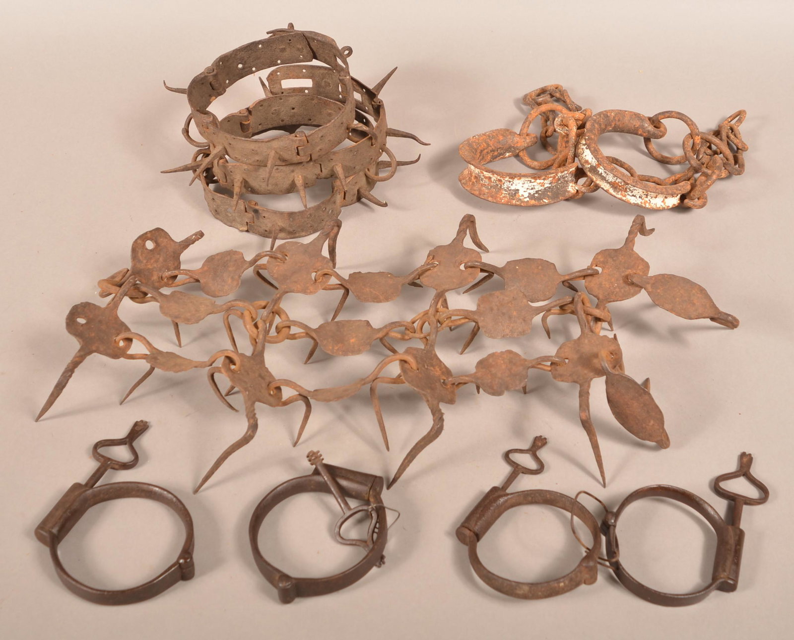 18th/Early 19th Century Wrought Iron Slave Shackles.: Lot of 18th/Early 19th Century Wrought Iron Slave Shackles. Including a rare slave punishment collar, wrist and ankle shackles. Condition: Good with pitting and rust.