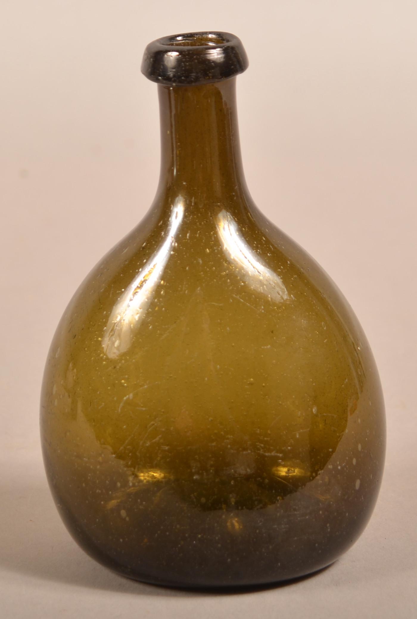 19th Century Blown Olive Green Glass Chestnut Bottle.: Early 19th Century Blown Olive Green Glass Chestnut Bottle. Applied tapered mouth, elongated neck, ovoid body and concave base with pontil. 6-5/8"h. Condition: Very good.
