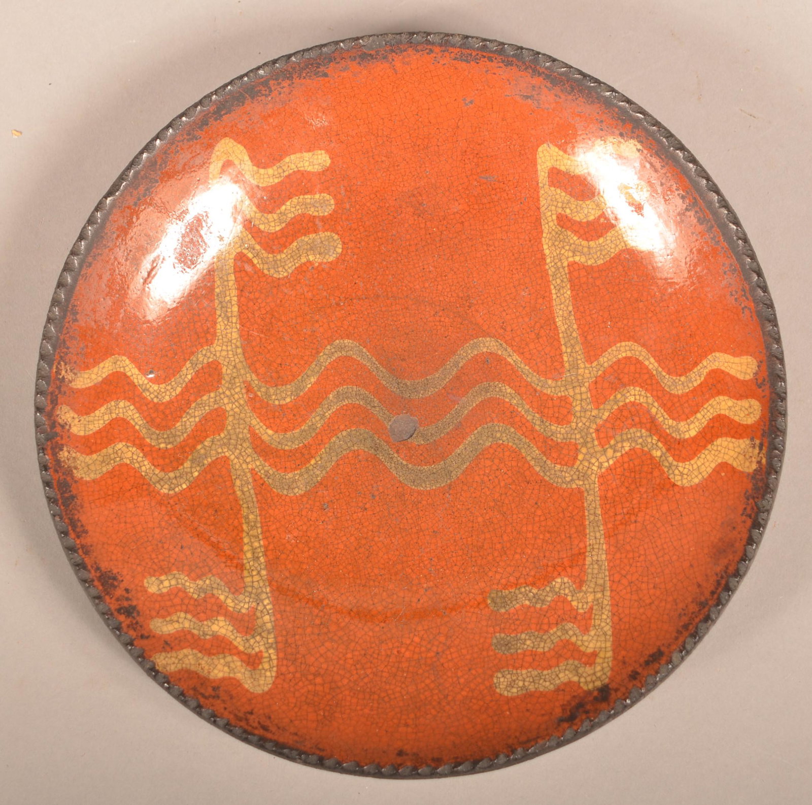 Pennsylvania 19th Century Redware Pottery Plate.: Pennsylvania 19th Century Redware Pottery Plate. Yellow slip-decoration, coggle wheel edge. 9" diam. Condition: Good with edge chips and surface ware.