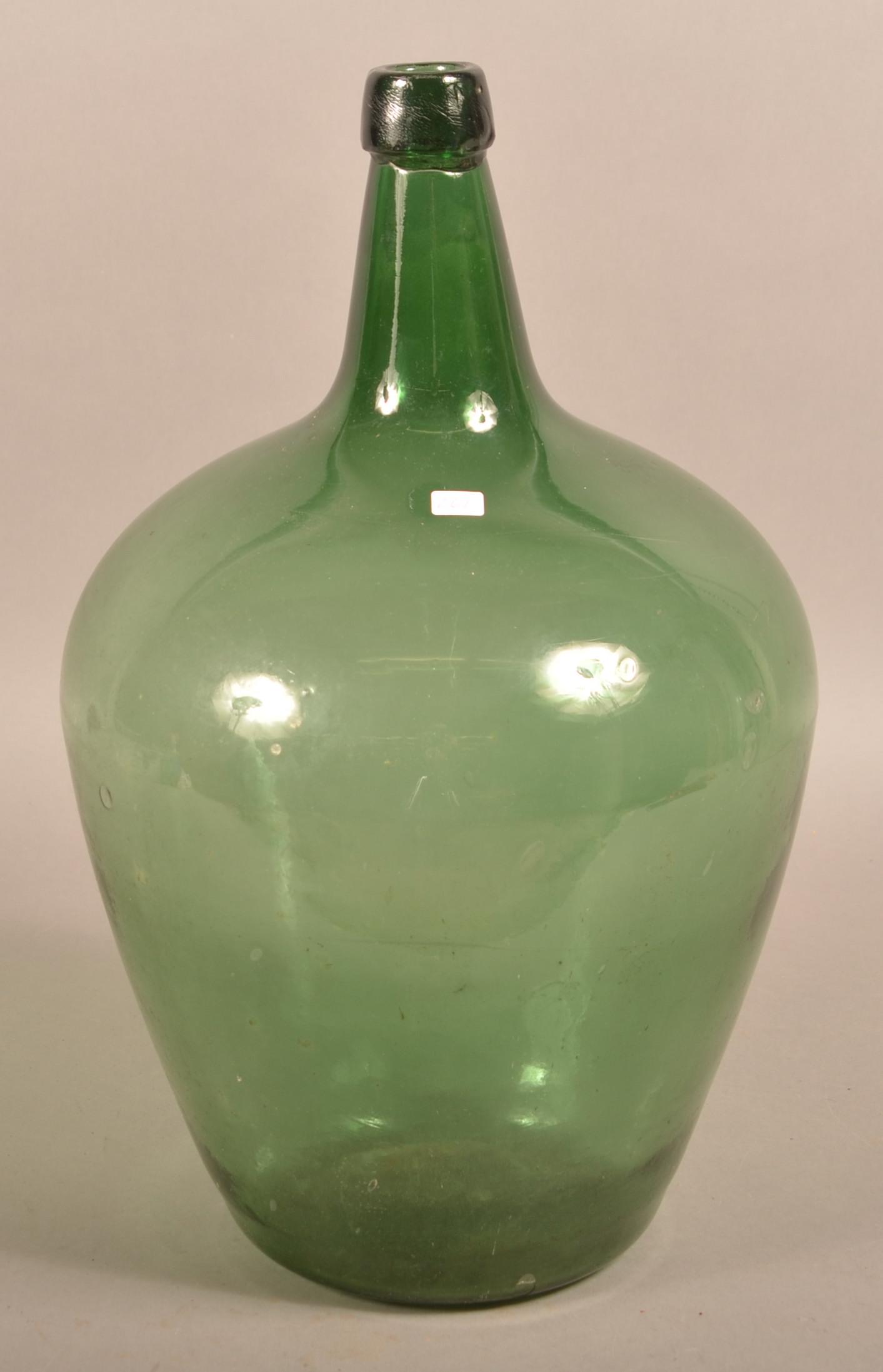 19th Century Blown Green Glass Demijohn Bottle.: 19th Century Blown Green Glass Demijohn Bottle. Tapered elongated spout with applied mouth, ovoid body and concave base. 19"h. Condition: Good with wear.