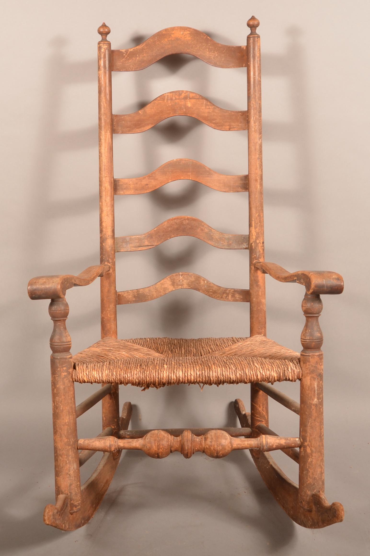 Delaware Valley Five-Slat Ladderback Rocking Chair.: Delaware Valley, Chester County, PA Five-Slat Ladderback Rocking Chair. Late 18th/Early 19th century. Turned finials, scrolled arms, rush seat and boldly turned front stretcher. Remnants of the origin
