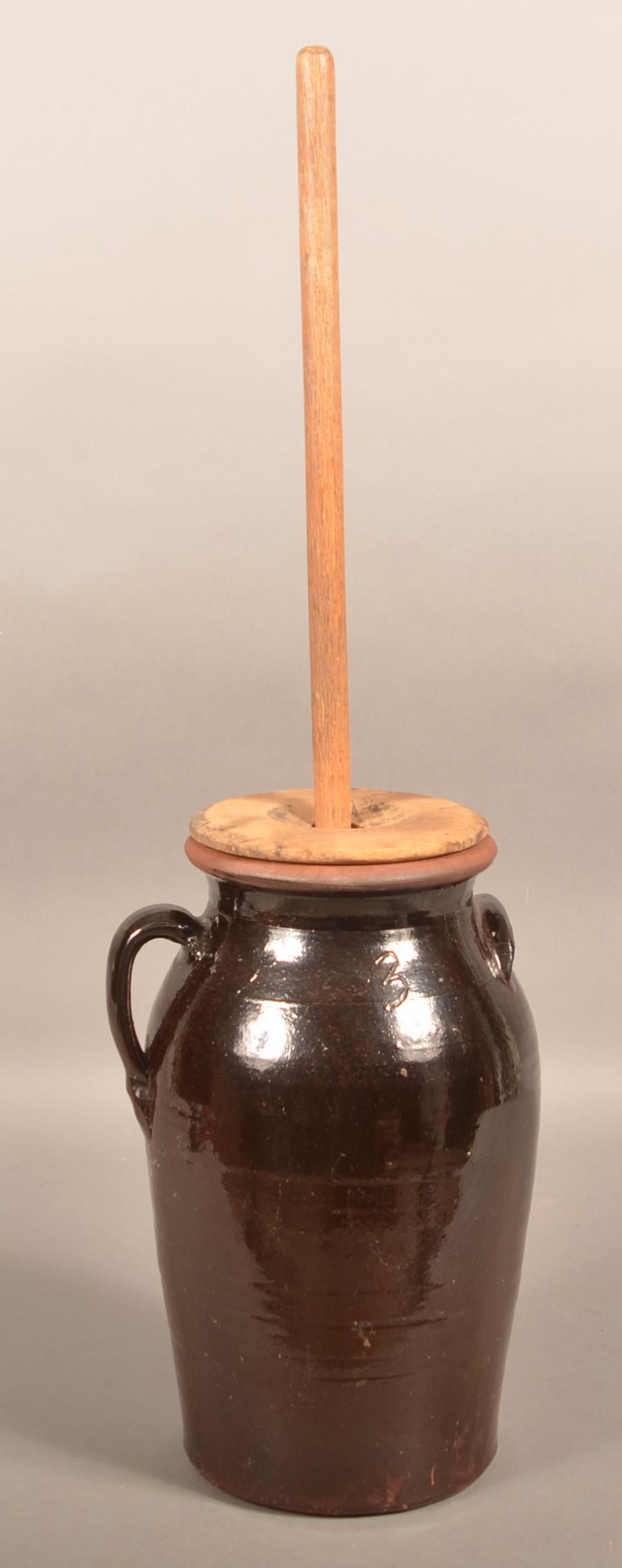 19th Century Manganese Glazed Redware Butter Churn.: 19th Century Manganese Glazed Redware Butter Churn. Three-gallon churn measures 16"h., 34"h. overall including wood dasher. Condition: Very good, dasher shows use wear.